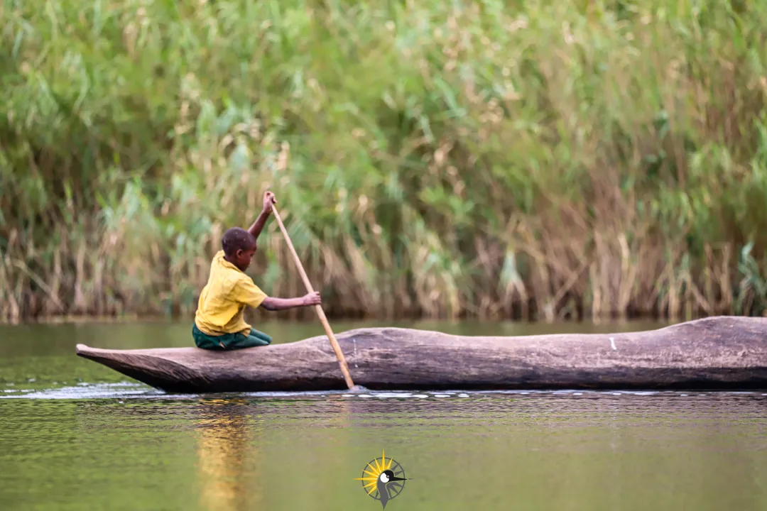 Kid on a canoe on Lake Bunyonyi